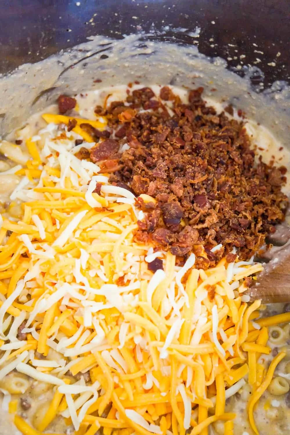shredded cheddar cheese and real bacon bits on top of pasta in an Instant Pot