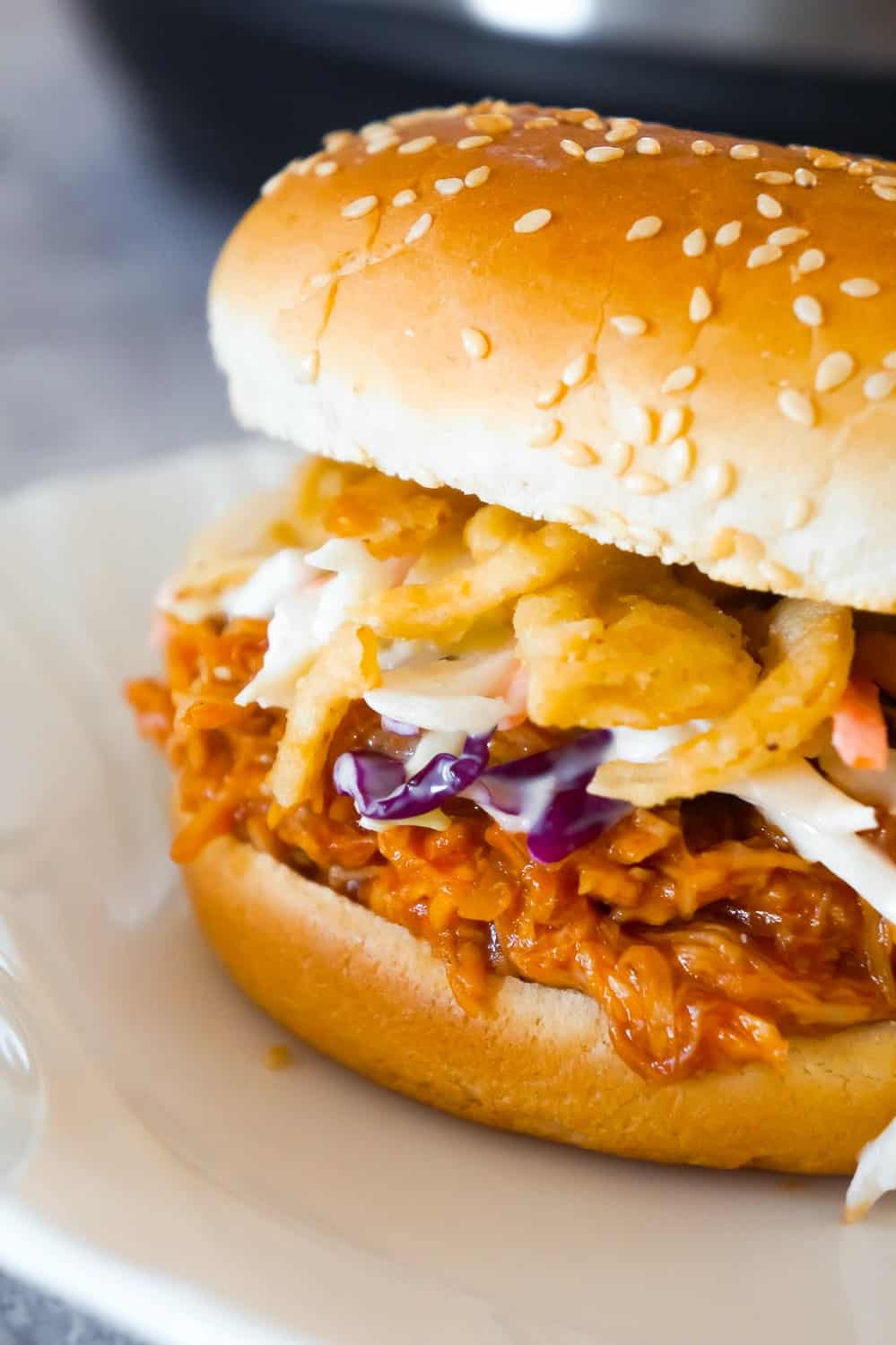 Instant Pot Honey BBQ Chicken Sandwiches are an easy and delicious dinner perfect for weeknights. These shredded chicken sandwiches with honey BBQ sauce are topped with coleslaw and French's fried onions.