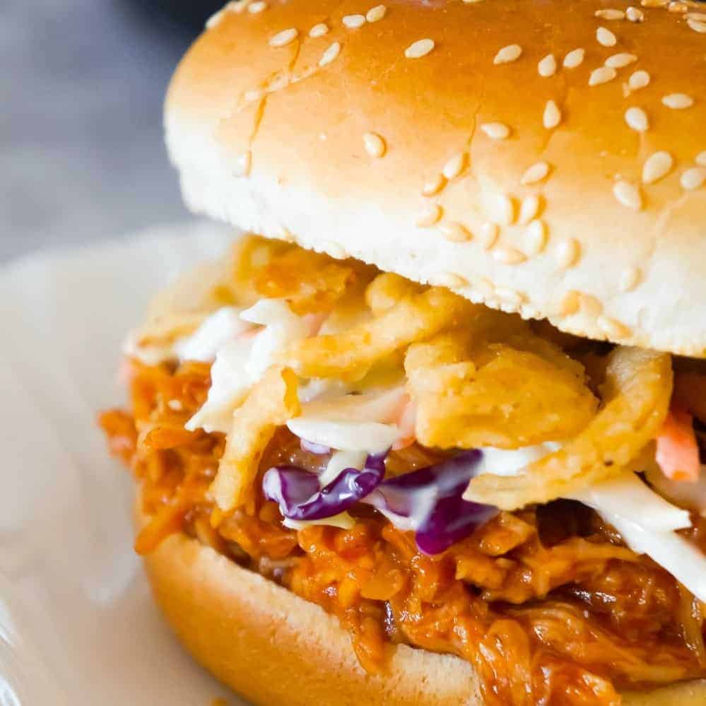 Instant Pot Honey BBQ Chicken Sandwiches are an easy and delicious dinner perfect for weeknights. These shredded chicken sandwiches with honey BBQ sauce are topped with coleslaw and French's fried onions.