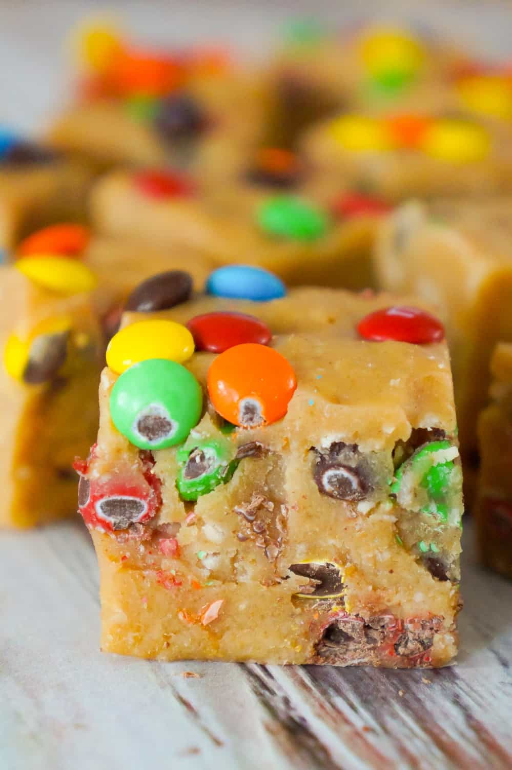 Monster Cookie Dough Fudge is an easy no bake microwave fudge recipe. This creamy fudge is made with peanut butter cookie dough mixed with Reese's peanut butter baking chips and condensed milk.