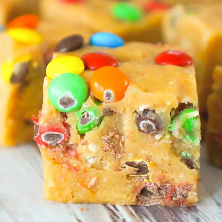 Monster Cookie Dough Fudge is an easy no bake microwave fudge recipe. This creamy fudge is made with peanut butter cookie dough mixed with Reese's peanut butter baking chips and condensed milk.