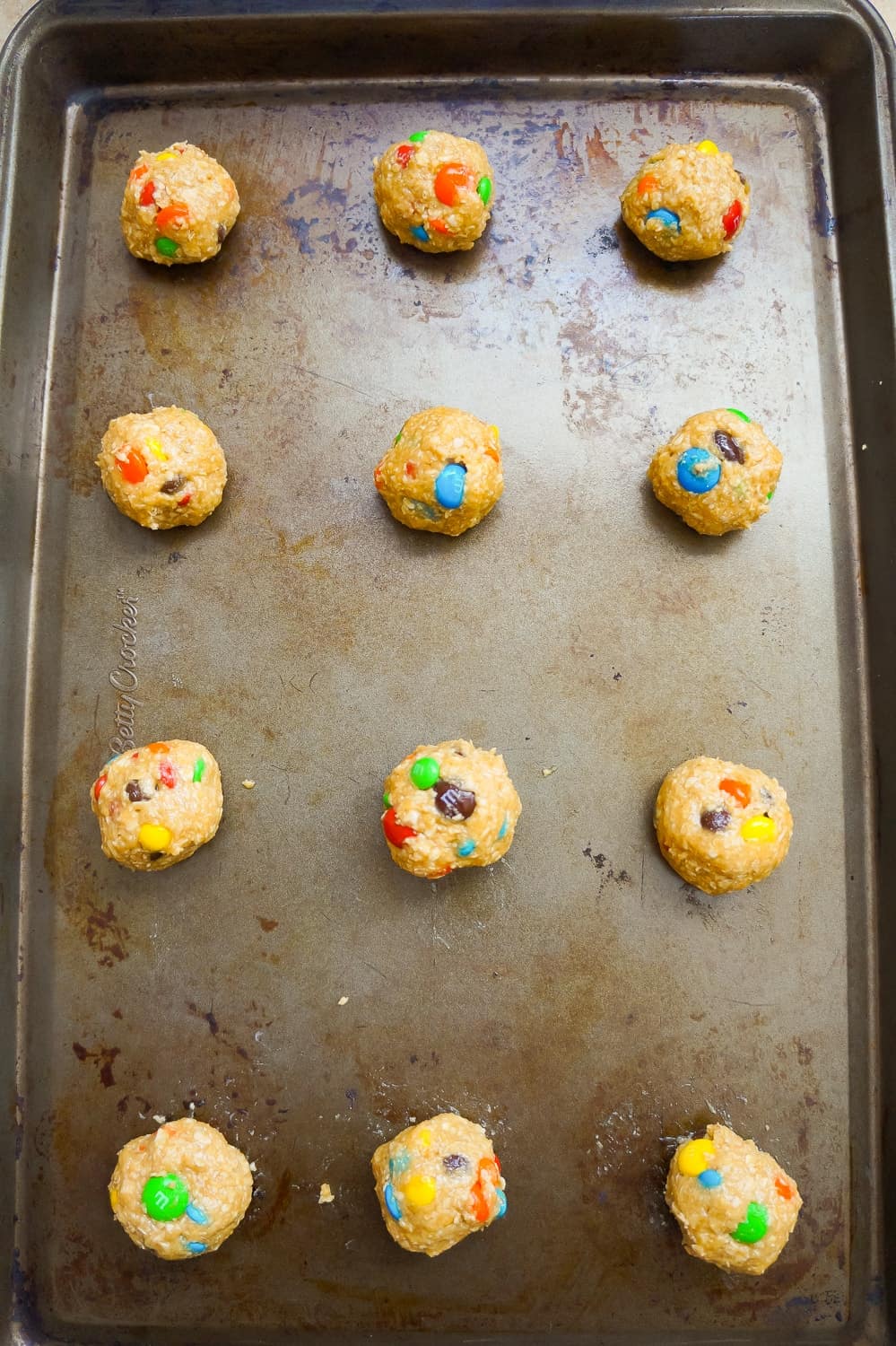 monster cookie dough balls on a baking sheet