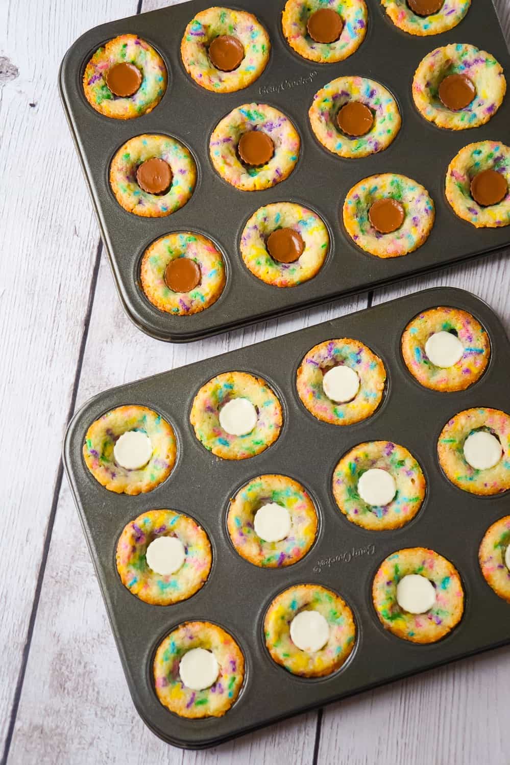 Peanut Butter Cup Sugar Cookies are a cute and colourful dessert perfect for spring. These sugar cookie cups are made in mini muffin tins and contain mini Reese's peanut butter cups and white chocolate peanut butter cups.