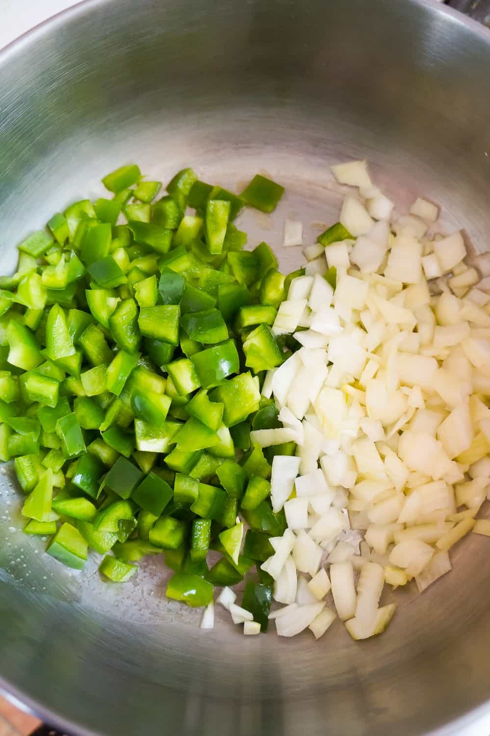 diced green peppers and diced onions in a large saucepan