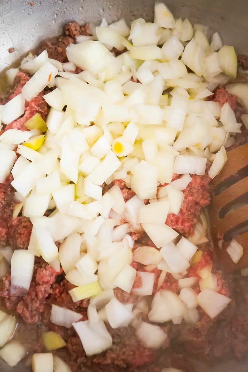 diced onions and ground beef in a pan