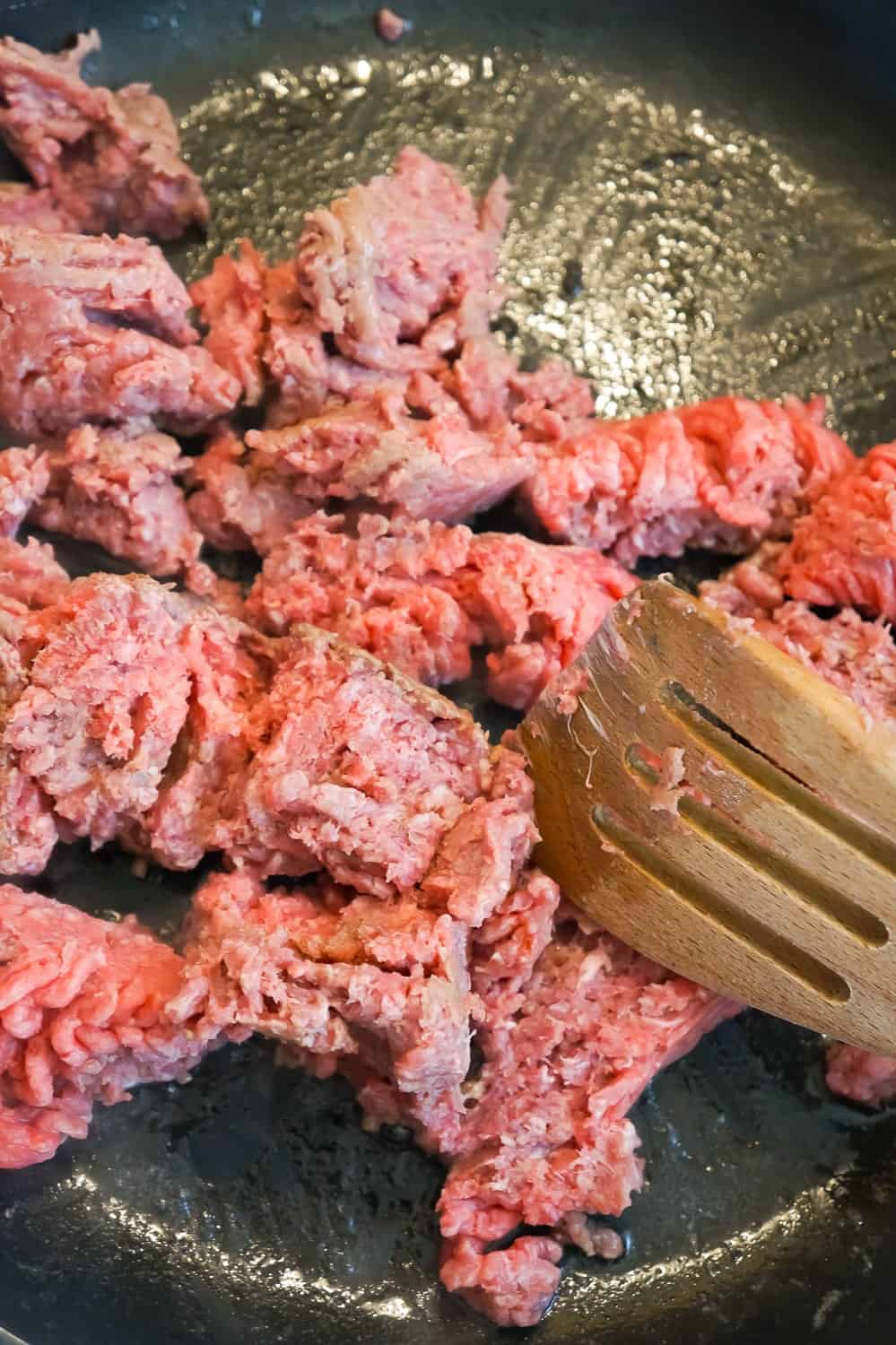 raw ground beef in a frying pan