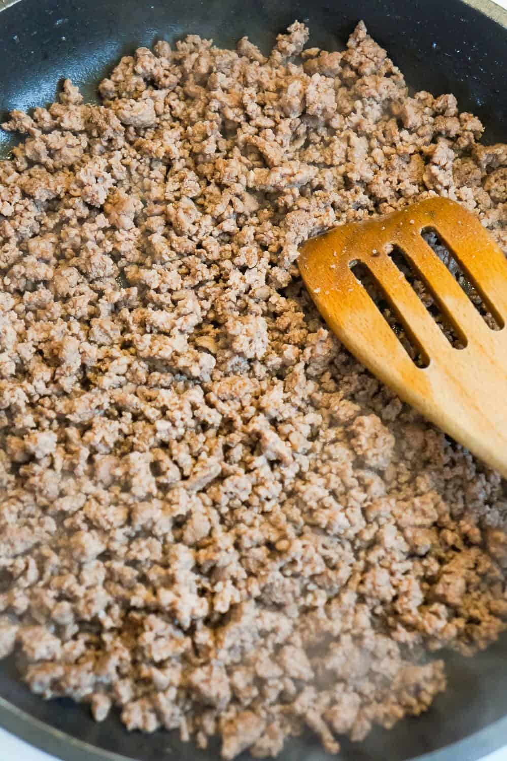 crumbled, cooked ground beef in a frying pan