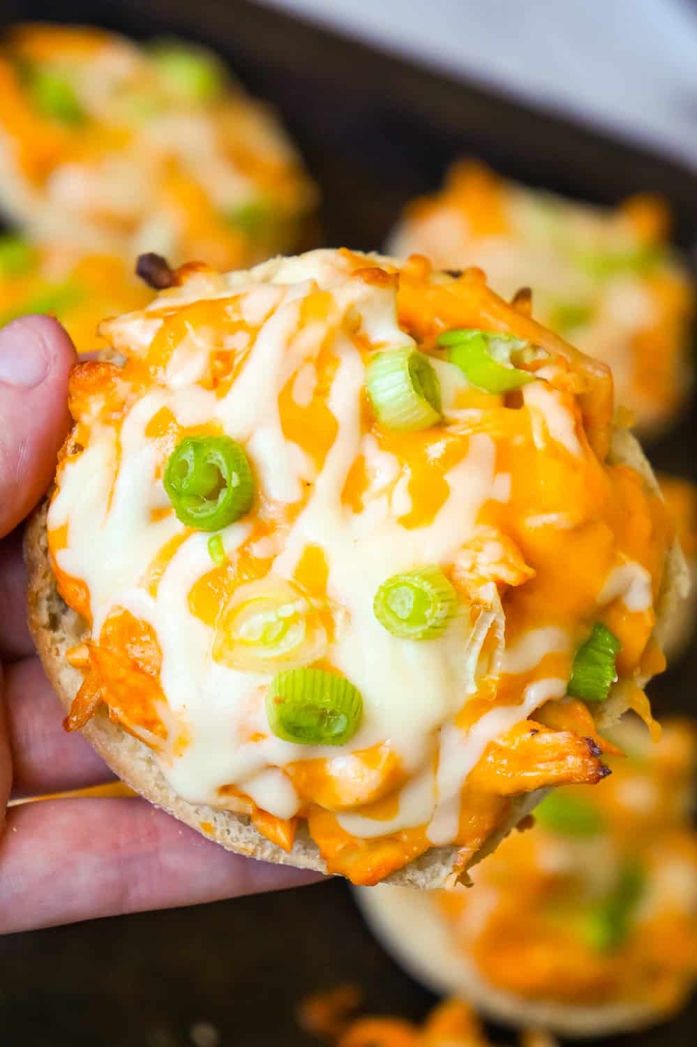 Buffalo Chicken English Muffins are an easy weeknight dinner recipe using rotisserie chicken. These English muffins are topped with shredded chicken tossed in Buffalo sauce and baked with cheese on top.