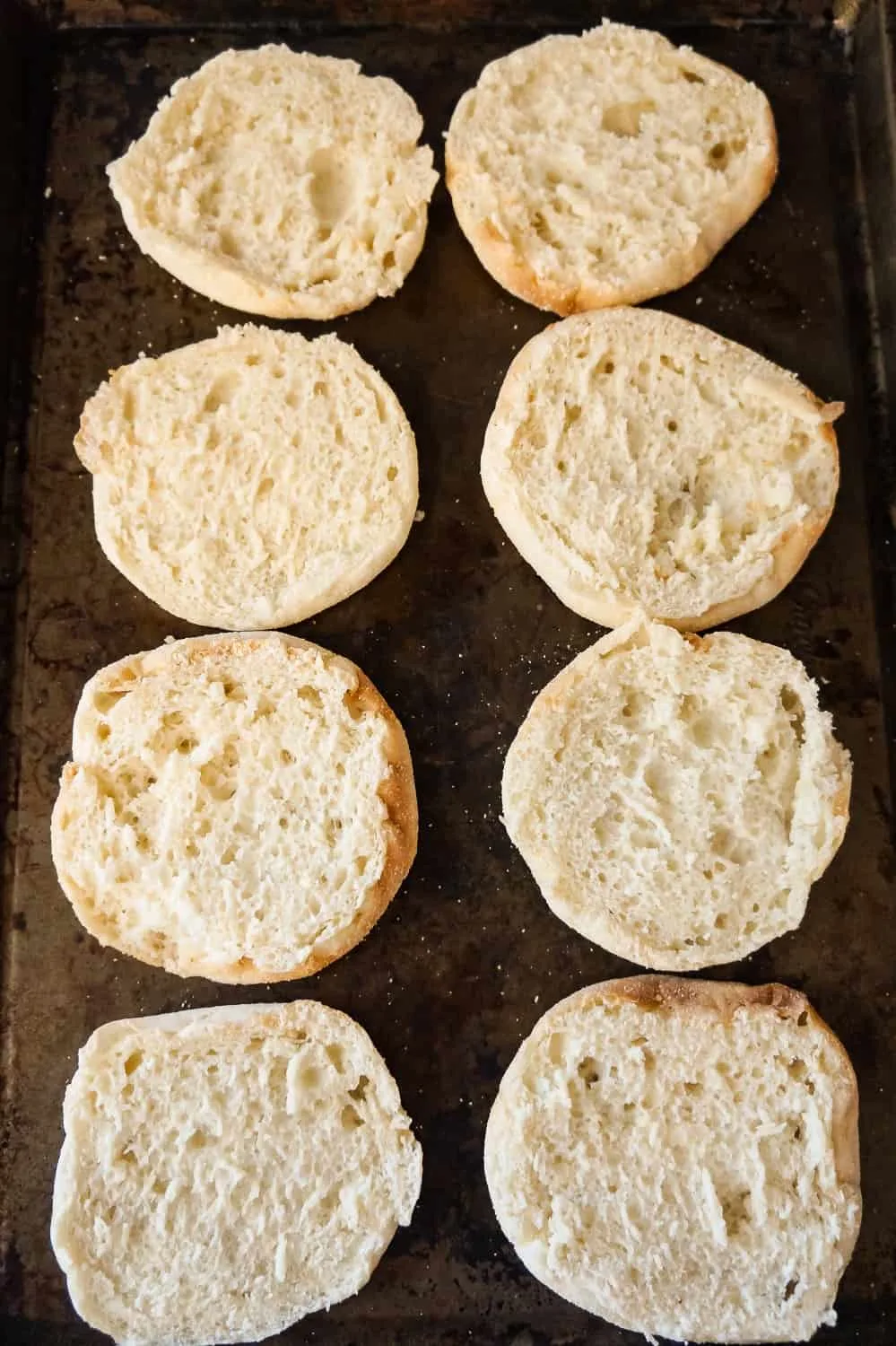 sliced English muffins on a baking sheet