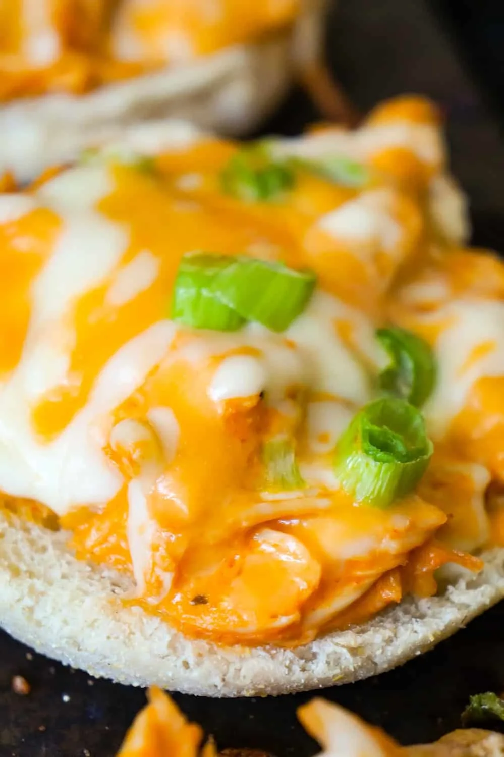 Buffalo Chicken English Muffins are an easy weeknight dinner recipe using rotisserie chicken. These English muffins are topped with shredded chicken tossed in Buffalo sauce and baked with cheese on top.