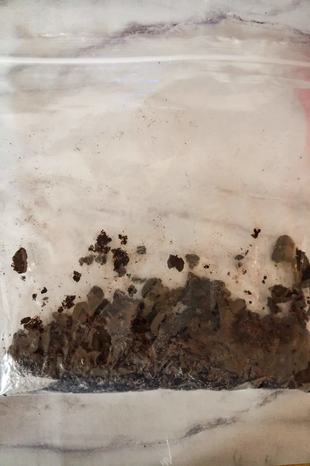 crumbled Oreo cookies in a Ziploc bag