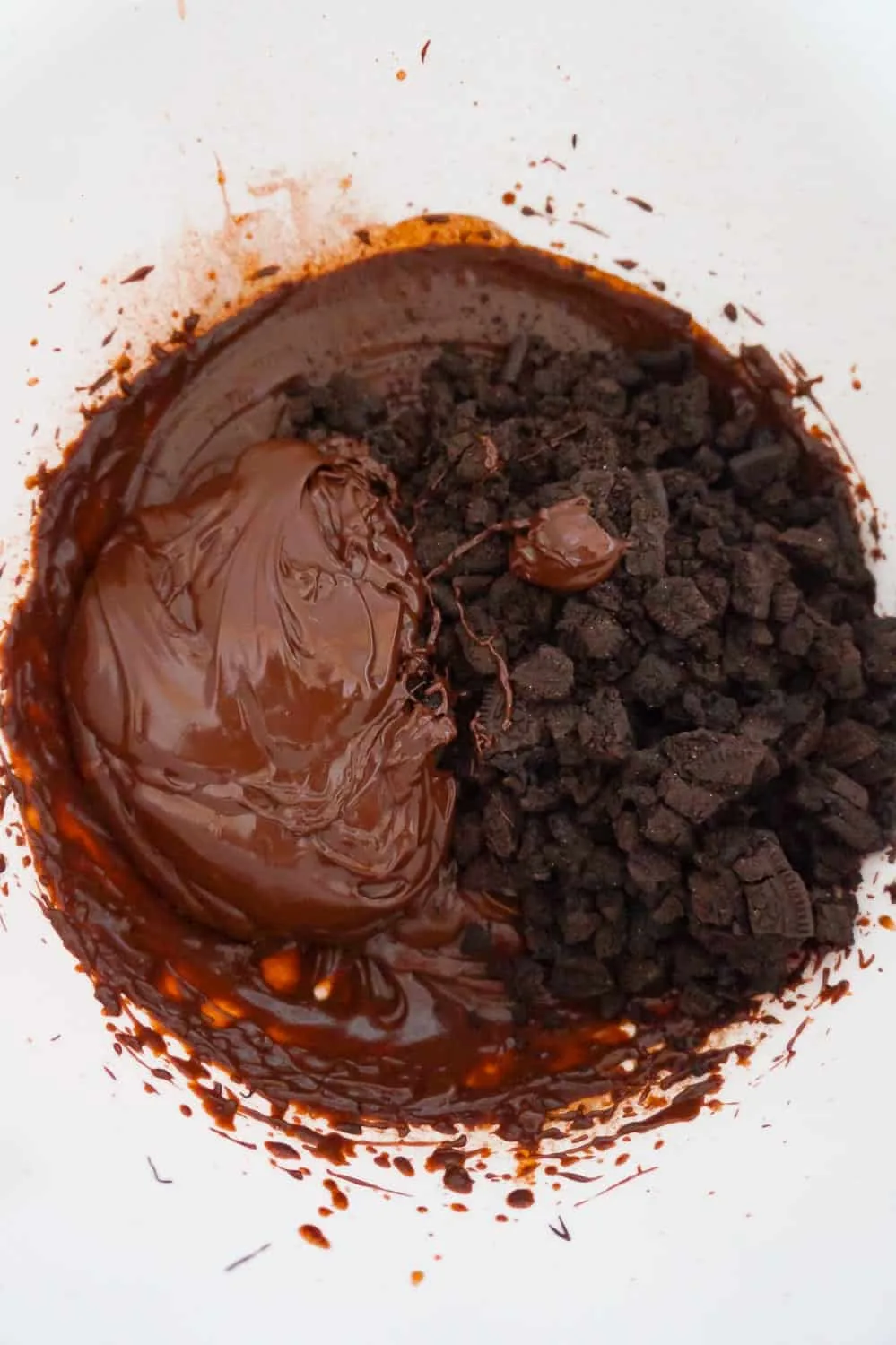 melted chocolate, crumbled Oreos and chocolate pudding in a mixing bowl