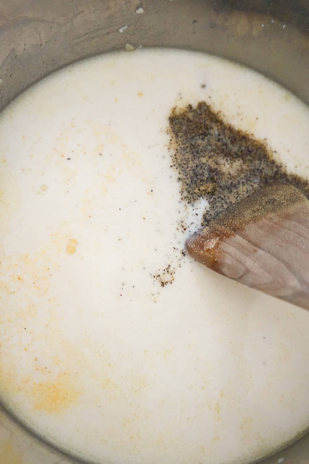 black pepper and onion powder on top of milk in an Instant Pot