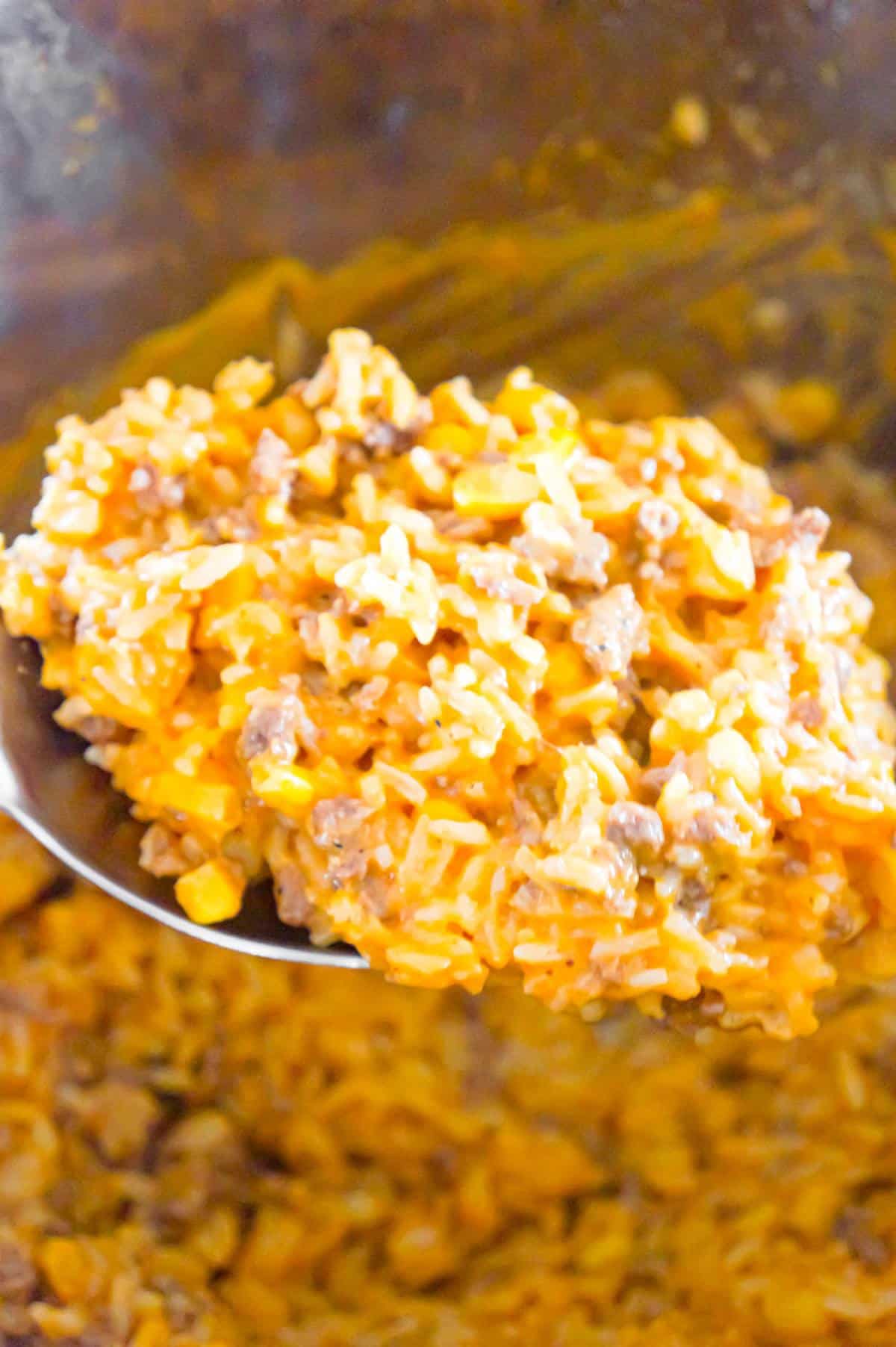 Instant Pot Cheesy Ground Beef and Rice is an easy pressure cooker ground beef and rice recipe loaded with corn and cheese in a creamy tomato sauce.