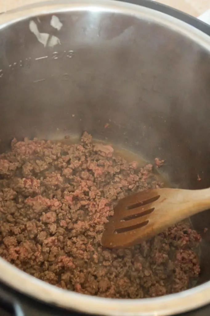 crumbled ground beef cooking in an Instant Pot