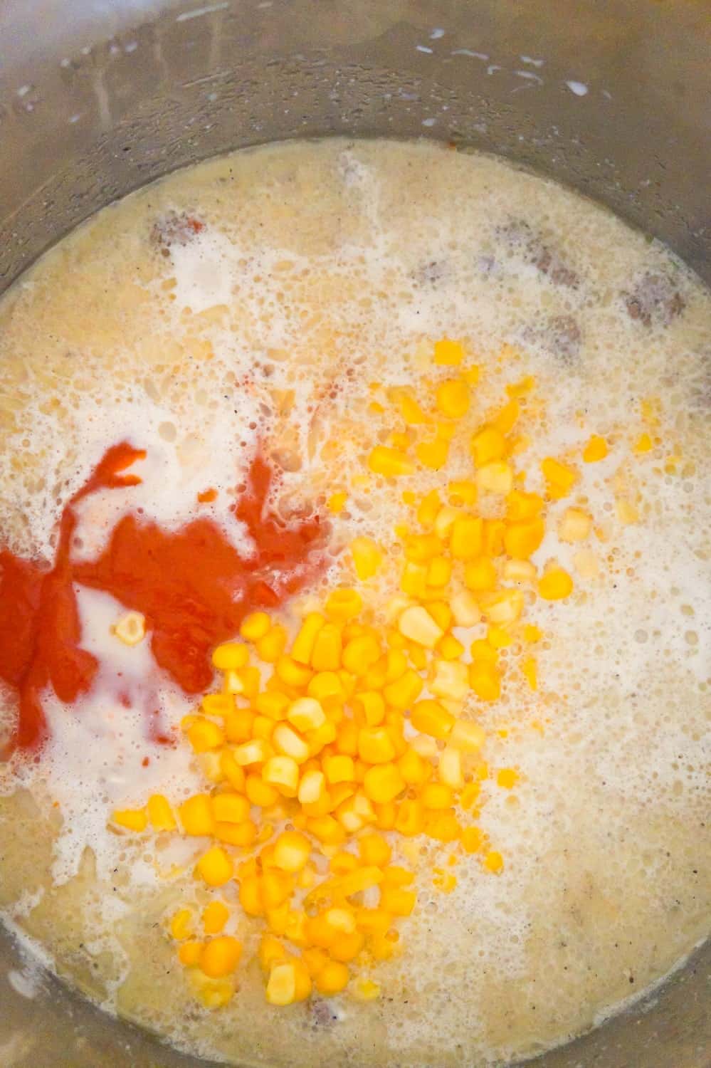 corn, condensed tomato soup and ground beef in milk in an Instant Pot