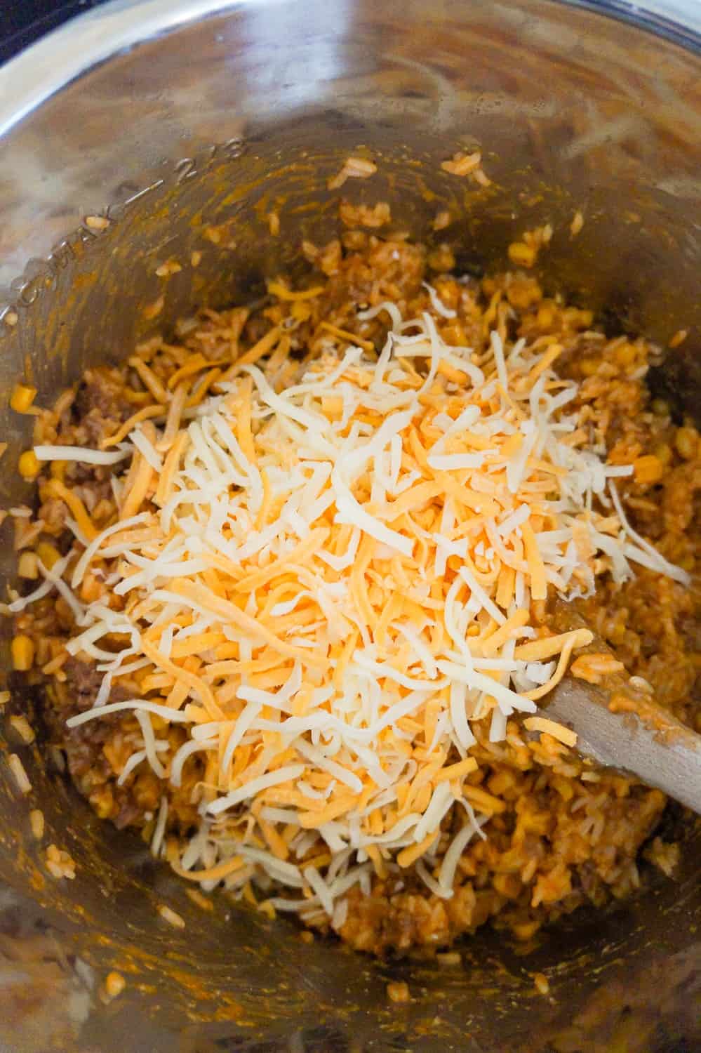 Instant Pot Cheesy Ground Beef and Rice is an easy dinner recipe perfect for weeknights. This Instant Pot rice dish is loaded with ground beef, corn, mozzarella and cheddar cheese.