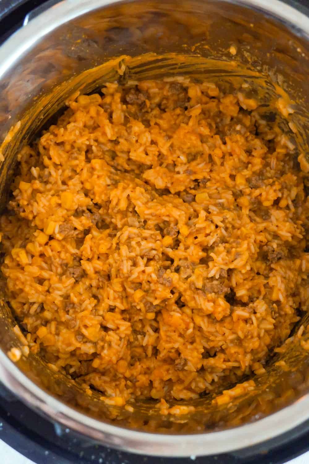 Instant Pot Cheesy Ground Beef and Rice is an easy dinner recipe perfect for weeknights. This Instant Pot rice dish is loaded with ground beef, corn, mozzarella and cheddar cheese.