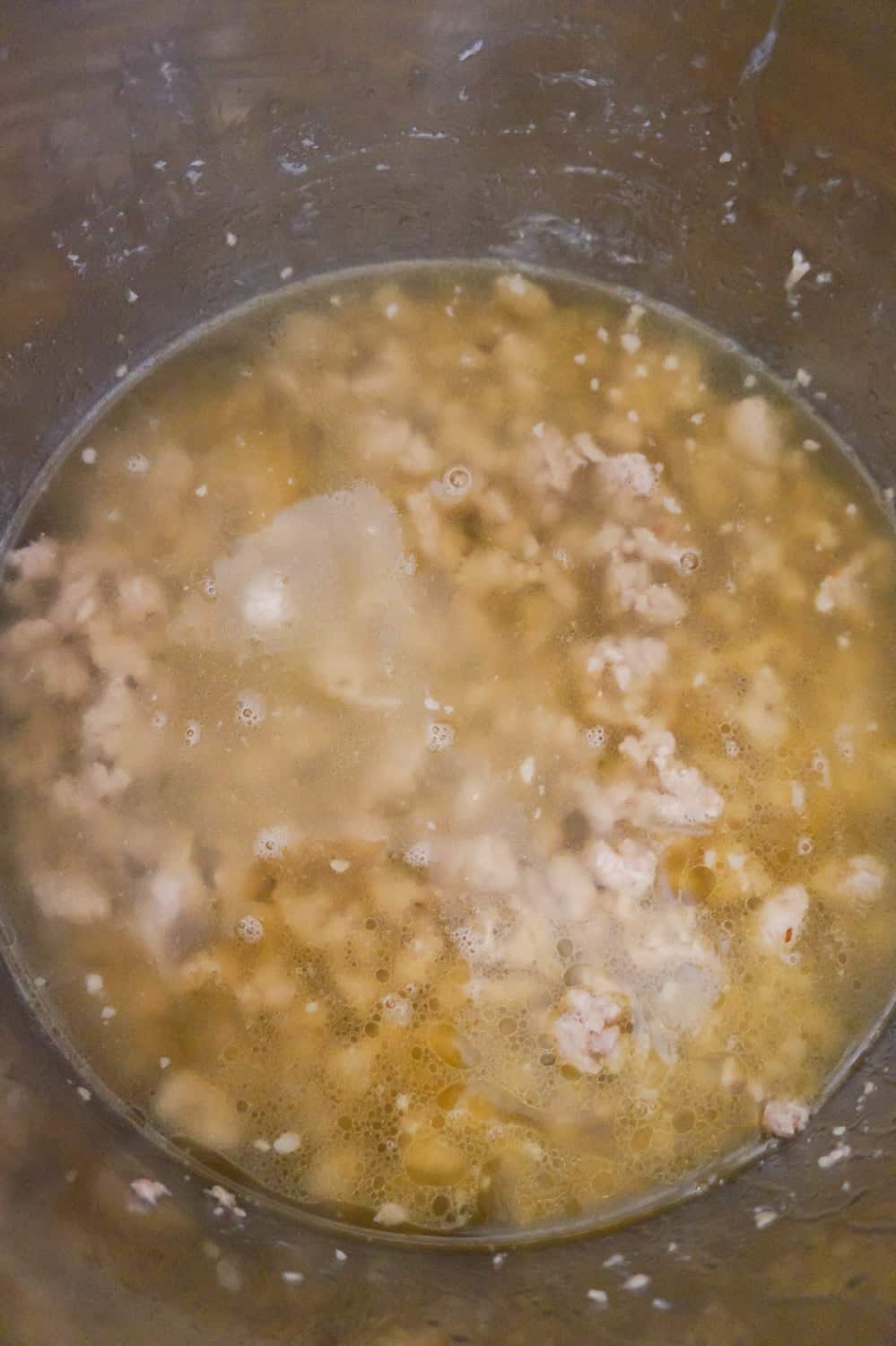 chicken broth and cooked ground sausage in an Instant Pot