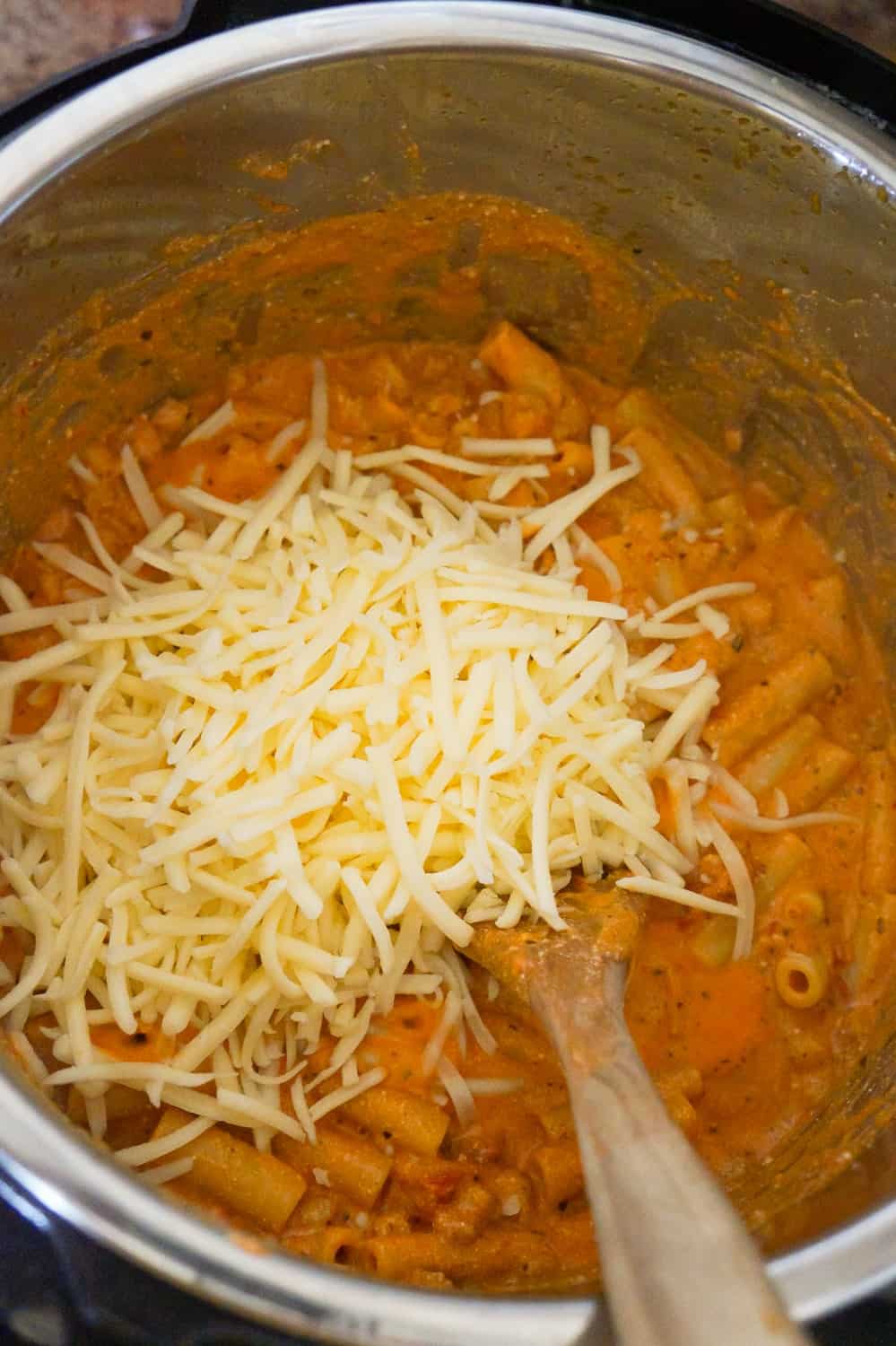 shredded mozzarella on top of creamy ziti in an Instant Pot