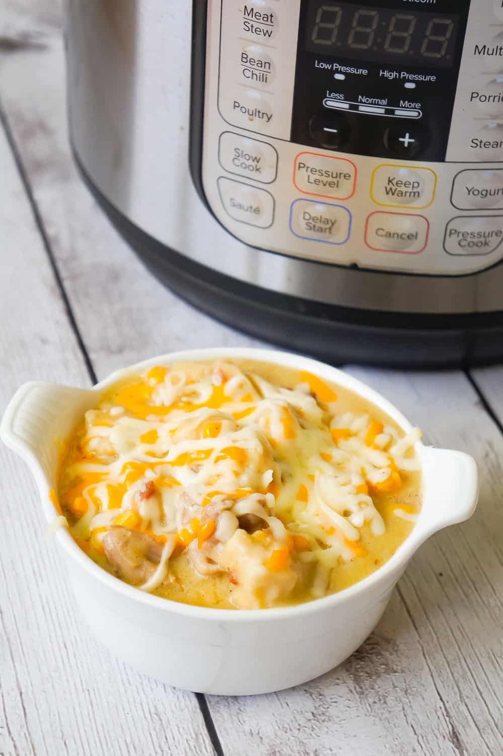 Instant Pot Chicken and Dumplings is an easy dinner recipe using boneless, skinless chicken thighs. This chicken and dumpling recipe uses Pillsbury refrigerated biscuit dough and is loaded with cheese and bacon.