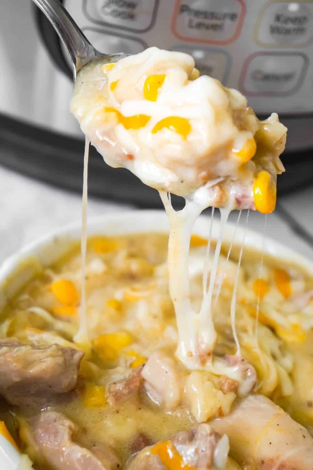 Instant Pot Chicken and Dumplings is an easy dinner recipe using boneless, skinless chicken thighs. This chicken and dumpling recipe uses Pillsbury refrigerated biscuit dough and is loaded with cheese and bacon.