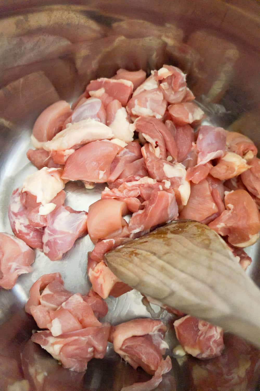 raw chicken thigh chunks in an Instant Pot