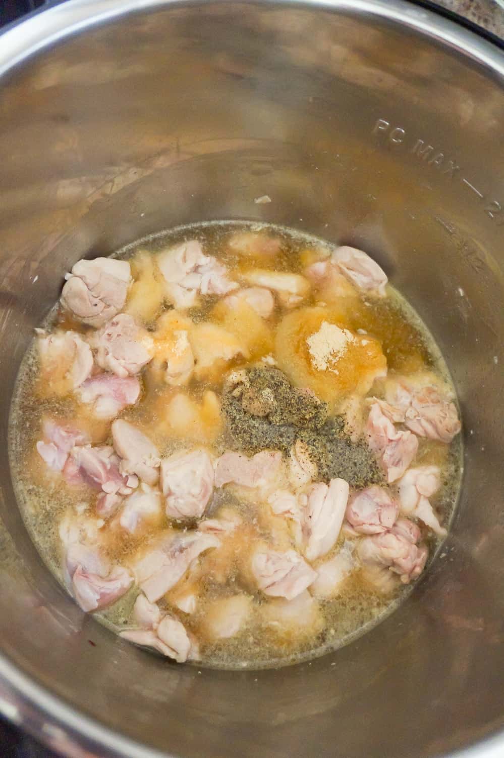 cubed chicken in chicken broth in an Instant Pot