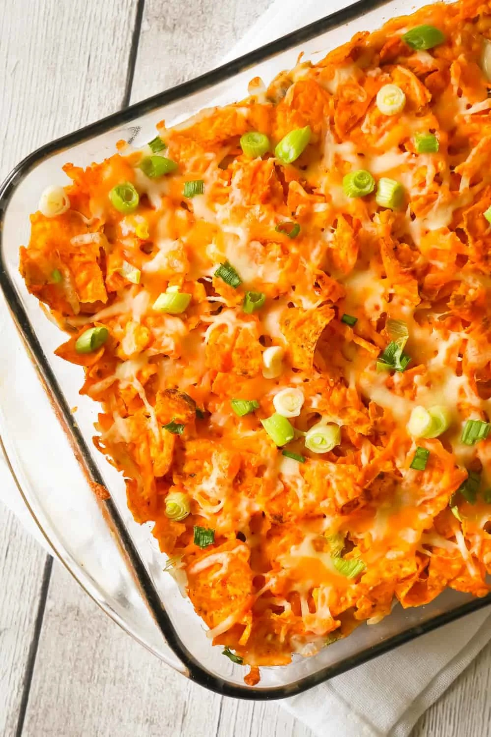 Doritos Casserole with Ground Beef is an easy dinner recipe the whole family will love. This hearty casserole is loaded with ground beef, cream cheese, corn, black beans, shredded cheese and topped with crumbled Doritos.