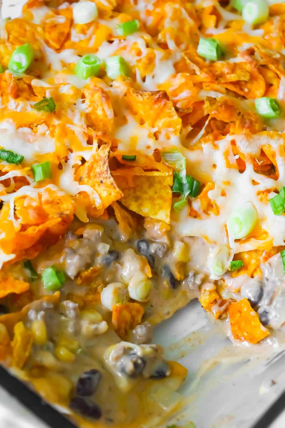 Doritos Casserole with Ground Beef is an easy dinner recipe the whole family will love. This hearty casserole is loaded with ground beef, cream cheese, corn, black beans, shredded cheese and topped with crumbled Doritos.