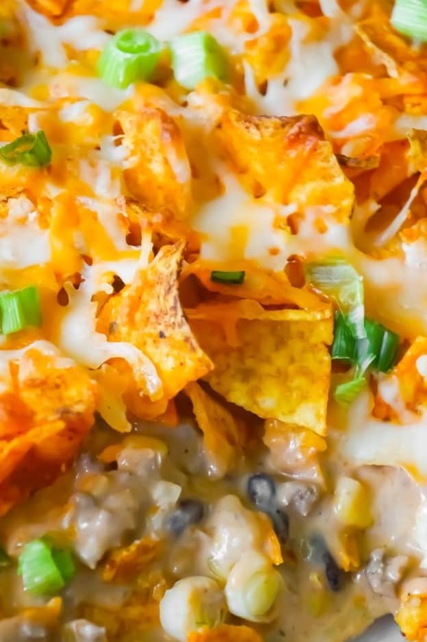 Doritos Casserole with Ground Beef is an easy dinner recipe the whole family will love. This hearty casserole is loaded with ground beef, cream cheese, corn, black beans, shredded cheese and topped with crumbled Doritos.