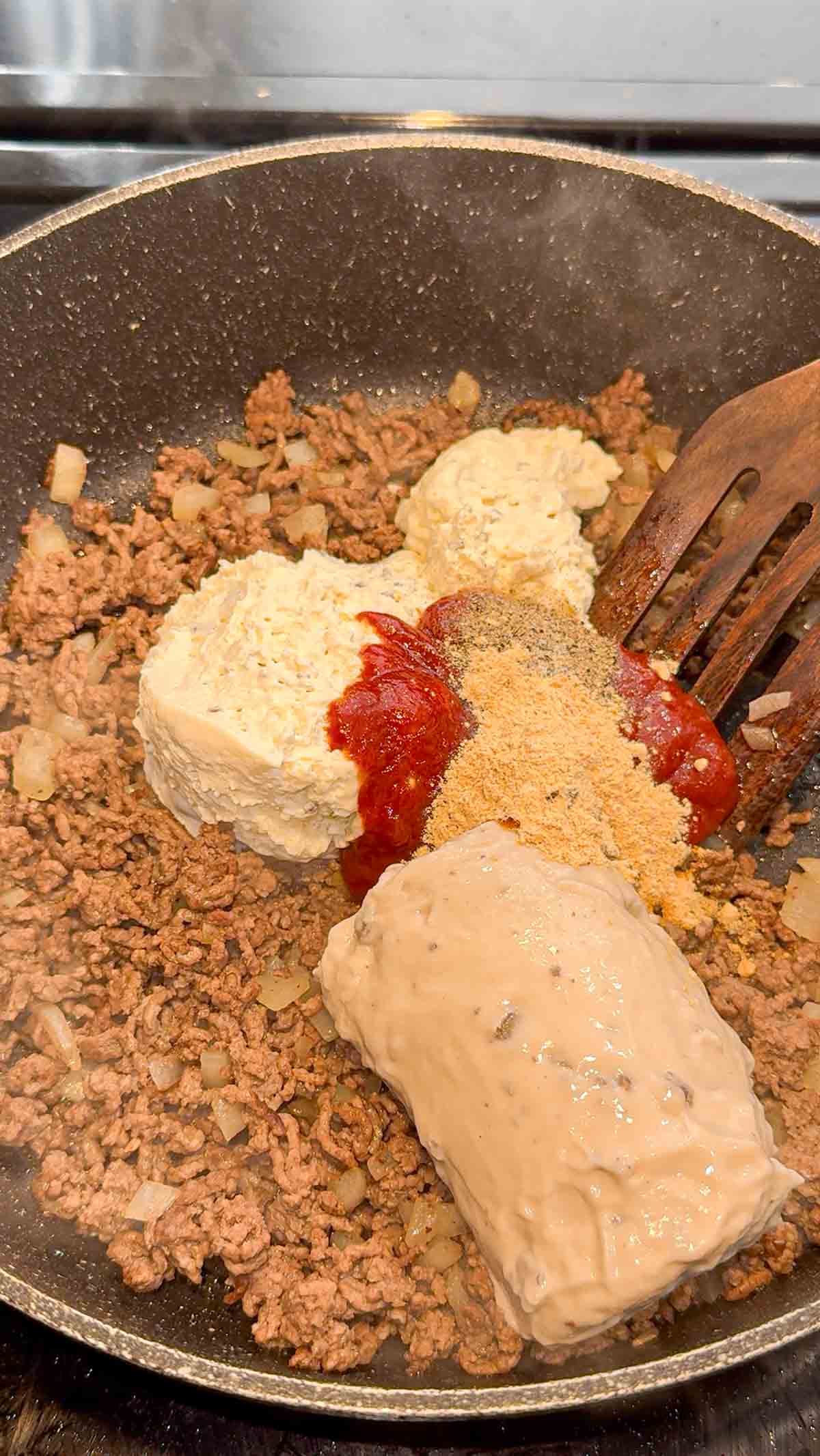 cream, cheese, cream of mushroom soup, chili sauce, salt, pepper and garlic powder add to skillet with cooked ground beef mixture
