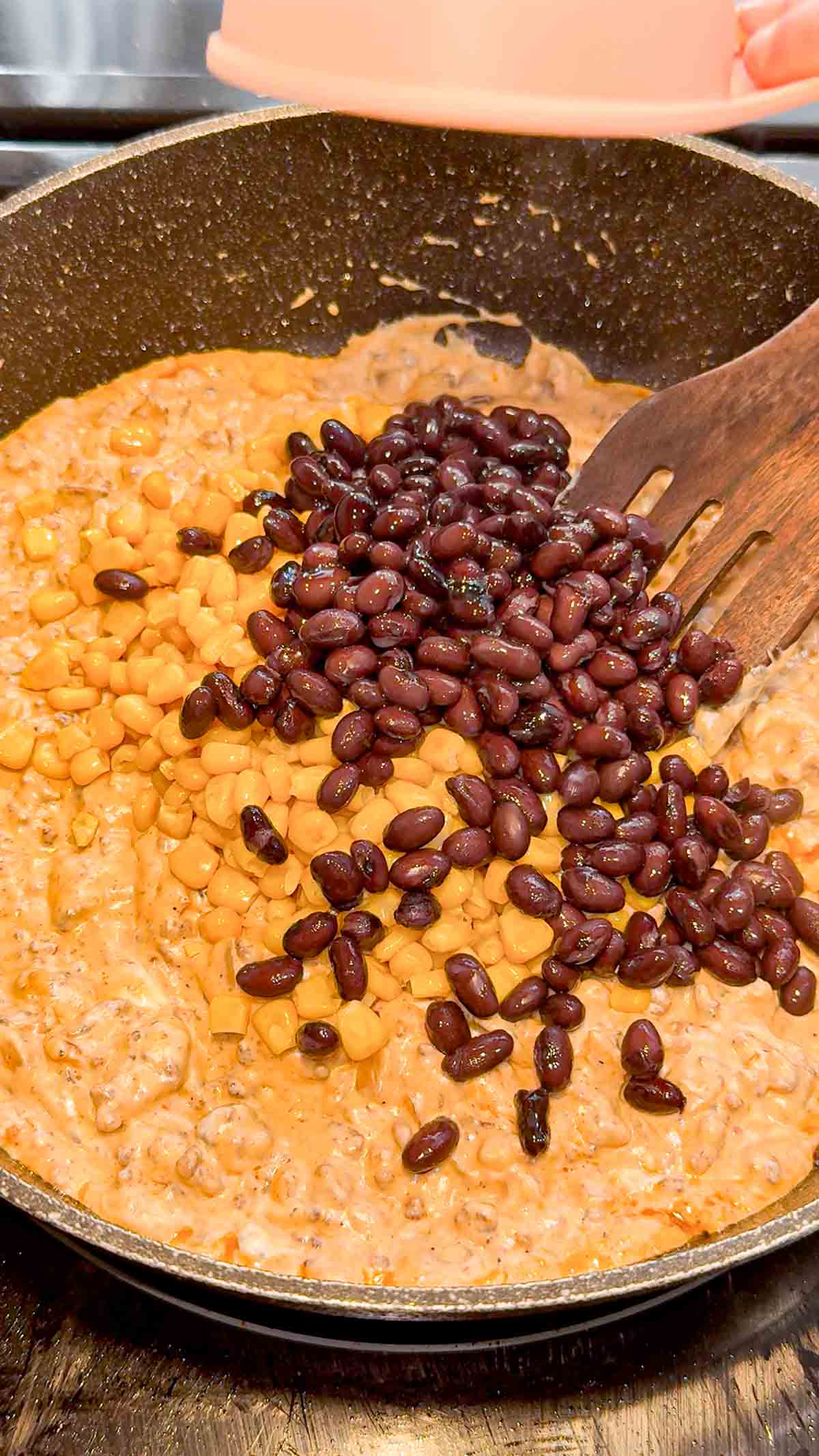 corn and black beans added to skillet with creamy ground beef mixture