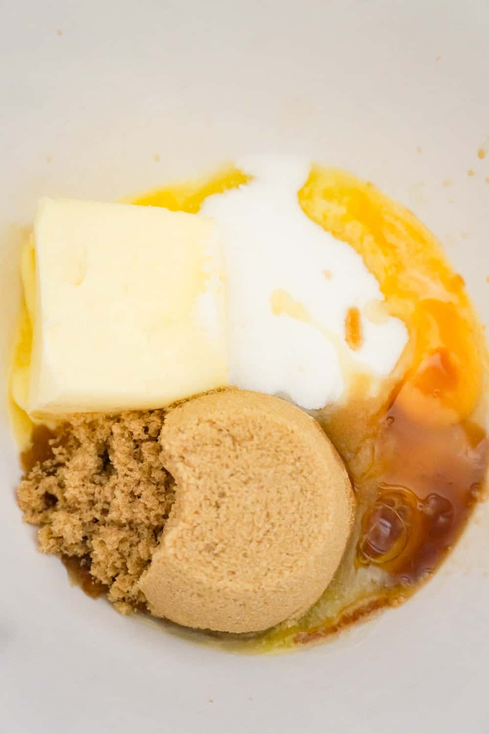 brown sugar, granulated sugar, softened butter, vanilla extract and an egg in a mixing bowl