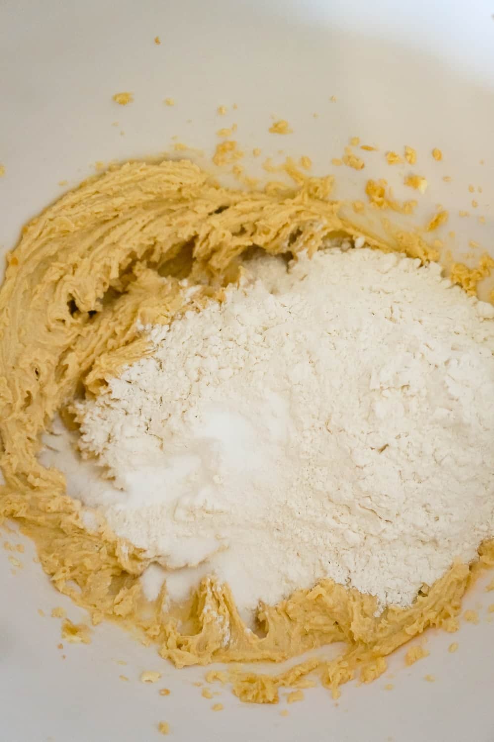 all purpose flour on top of creamed mixture in a mixing bowl