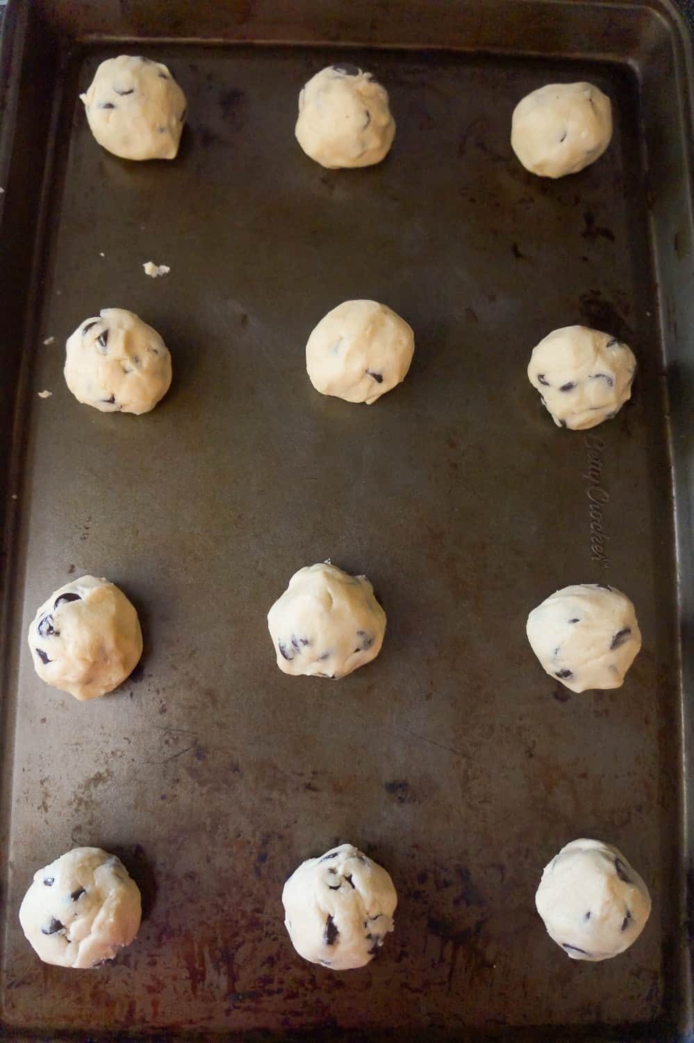 chocolate chip cookie dough balls on a baking sheet