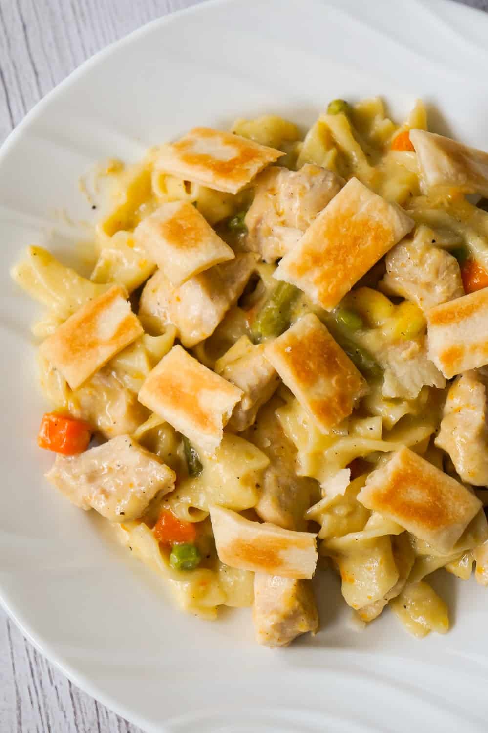 Instant Pot Chicken Pot Pie Pasta is an easy chicken dinner recipe perfect for when you are short on time. This creamy egg noodle pasta is loaded with chicken breast, veggies and topped with strips of Pillsbury pie crust.