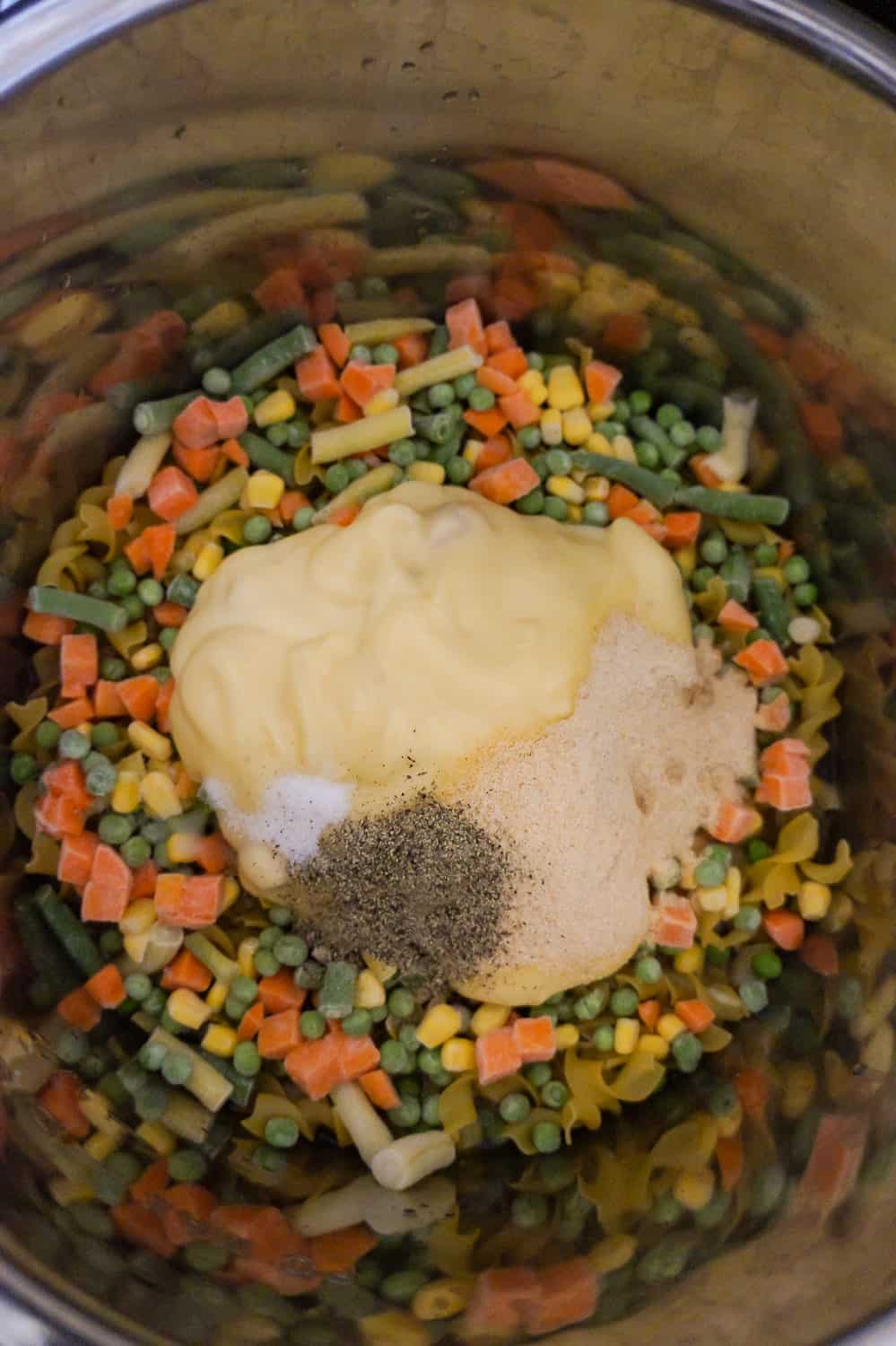 frozen veggies, cream of chicken soup, onion powder salt and pepper in an Instant Pot