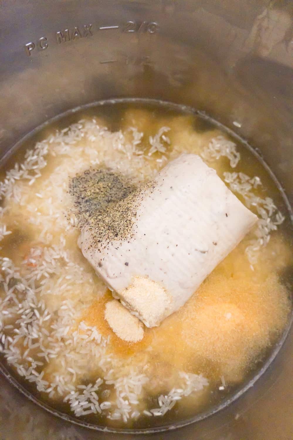 cream of mushroom soup, garlic powder, onion powder, salt, pepper and rice on top of meatballs in an Instant Pot