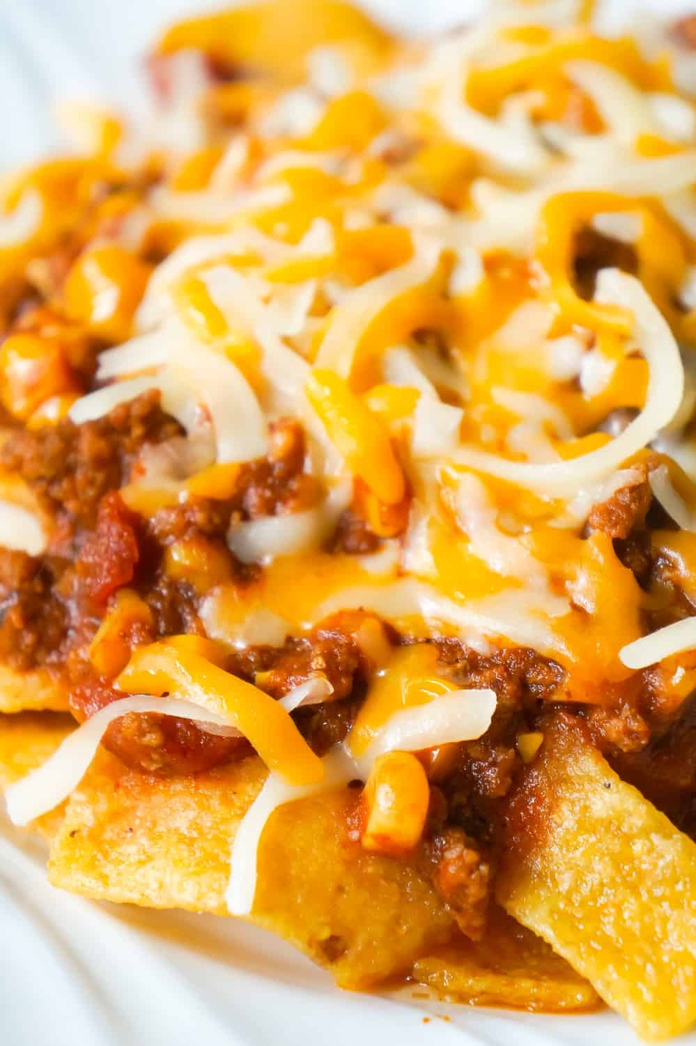 Instant Pot Frito Pie is an easy ground beef dinner recipe the whole family will love. A delicious ground beef and corn chili mixture is cooked in the Instant Pot and then poured over Frito's corn chips and topped with shredded cheese.