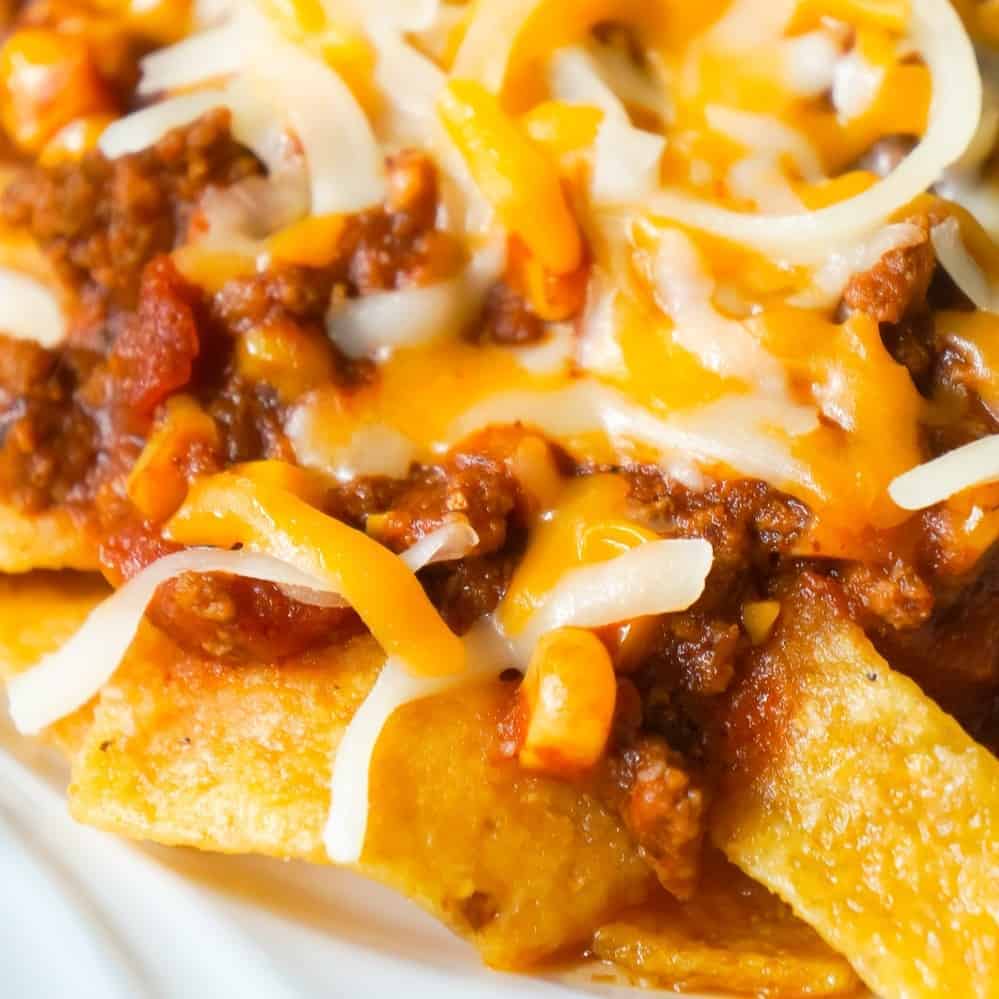 Instant Pot Frito Pie is an easy ground beef dinner recipe the whole family will love. A delicious ground beef and corn chili mixture is cooked in the Instant Pot and then poured over Frito's corn chips and topped with shredded cheese.