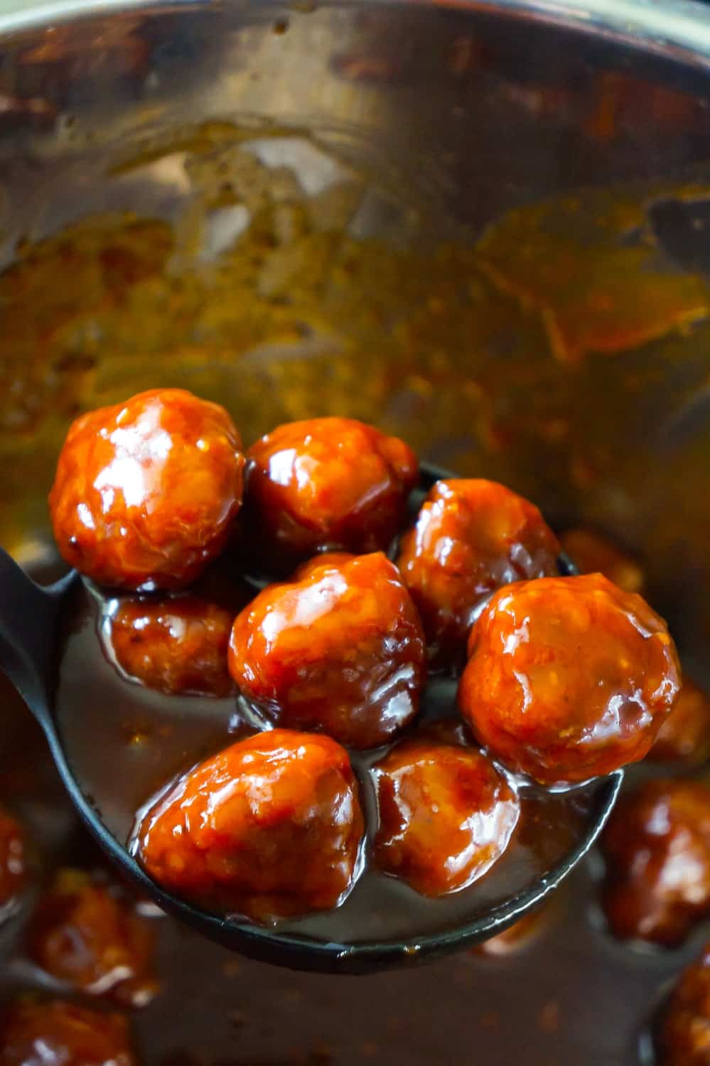 Instant Pot Grape Jelly Meatballs are the perfect party food. These tasty meatballs are coated in Welsh's Grape Jelly and Sweet Baby Ray's Hickory and Brown Sugar BBQ Sauce.