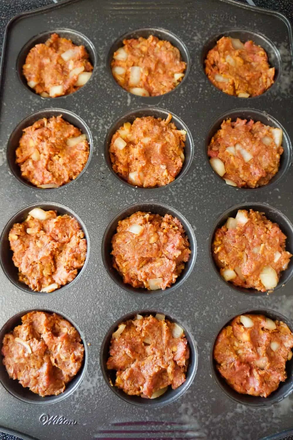 meatloaf mixture pressed into muffin tins