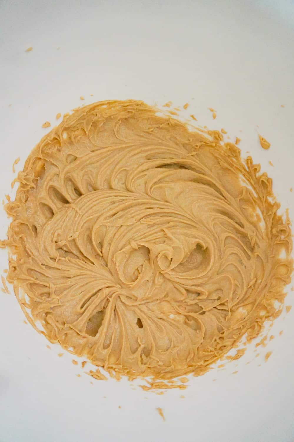 creamy peanut butter and butter mixture in a mixing bowl