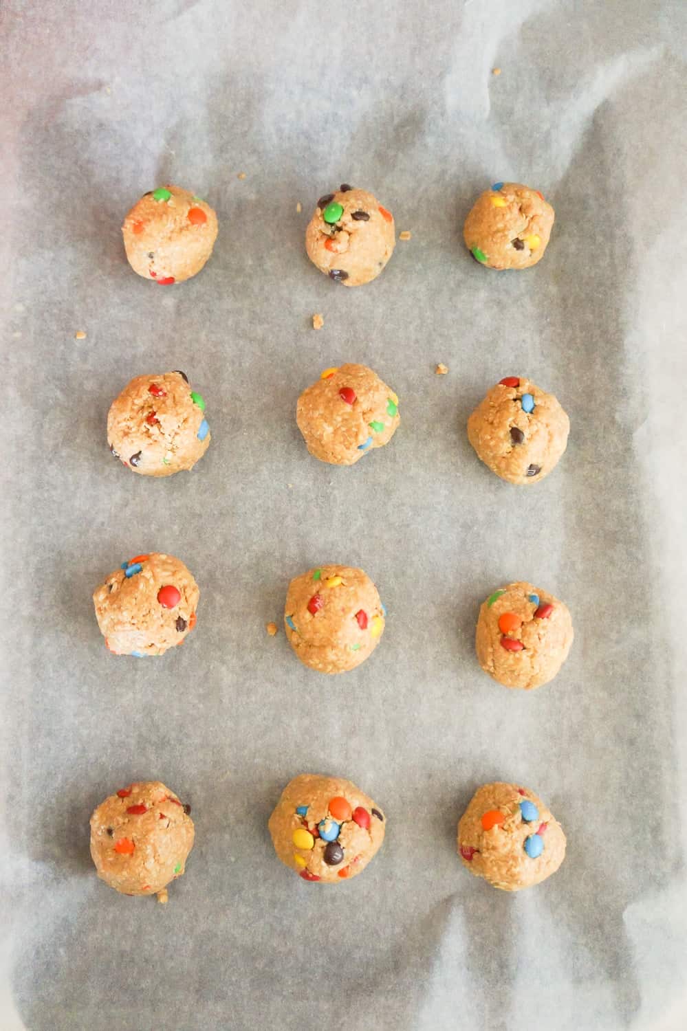 monster cookie dough balls on parchment paper