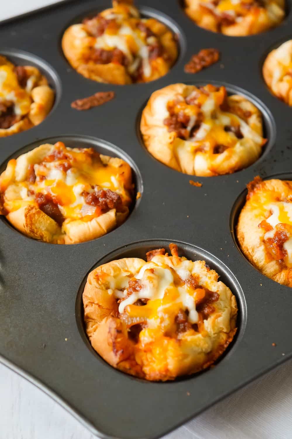 Sloppy Joe Cups are an easy recipe perfect for a fun weeknight dinner or to serve at a party. These hamburger bun cups are filled with ground beef tossed in homemade sloppy joe sauce.