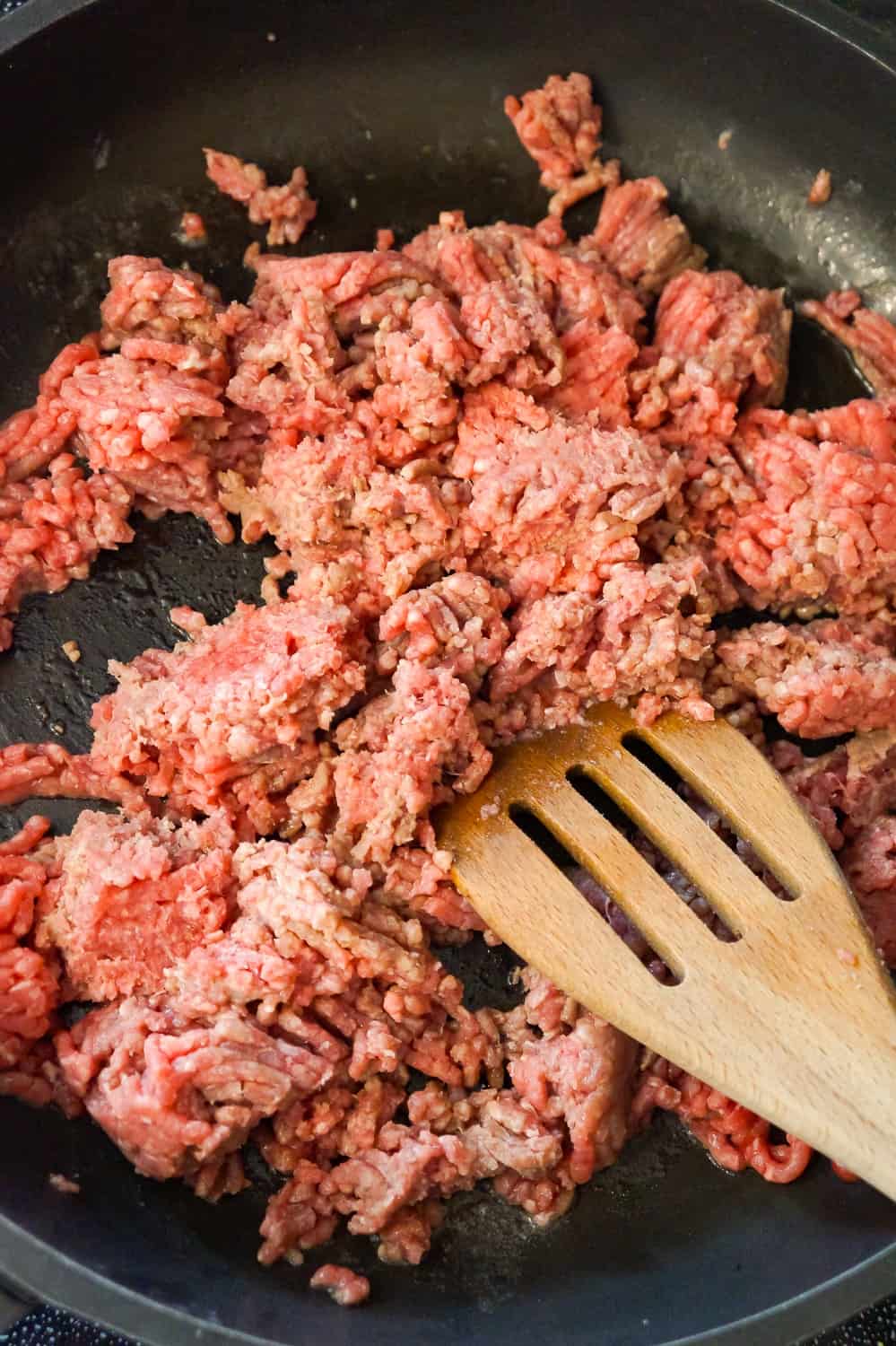 ground beef cooking in a frying pan