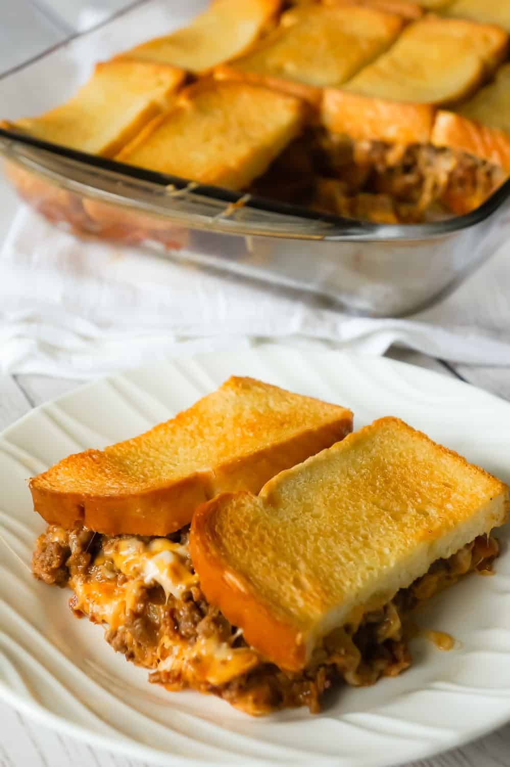 Bacon Cheeseburger Grilled Cheese Casserole is an easy dinner recipe the whole family will love. This delicious casserole is loaded with ground beef, bacon, onions and cheese sandwiched between layers of bread.