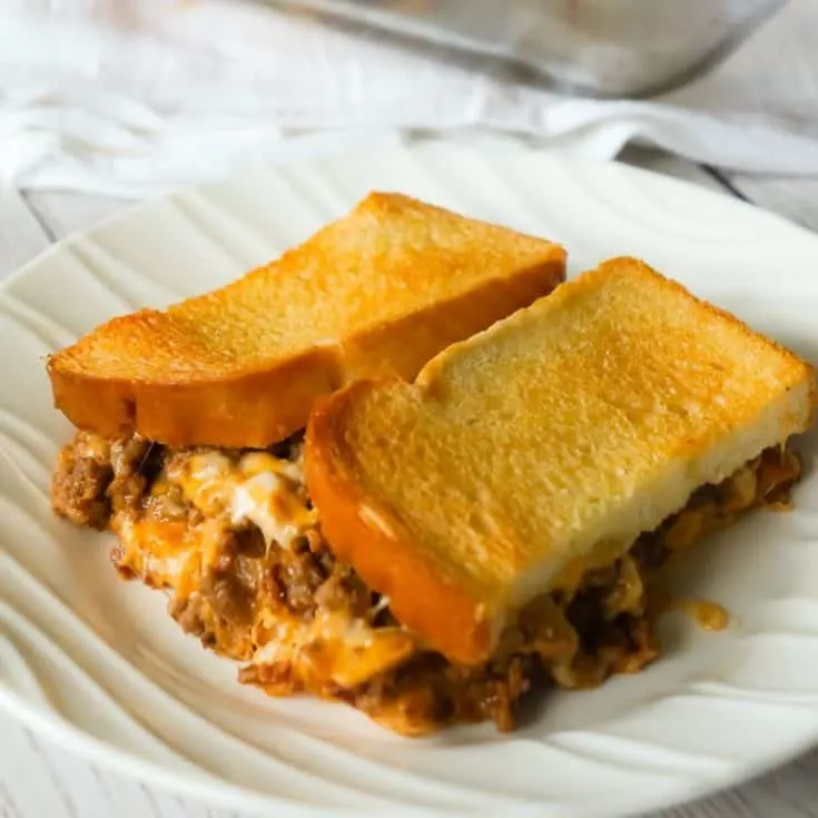 Bacon Cheeseburger Grilled Cheese Casserole is an easy dinner recipe the whole family will love. This delicious casserole is loaded with ground beef, bacon, onions and cheese sandwiched between layers of bread.