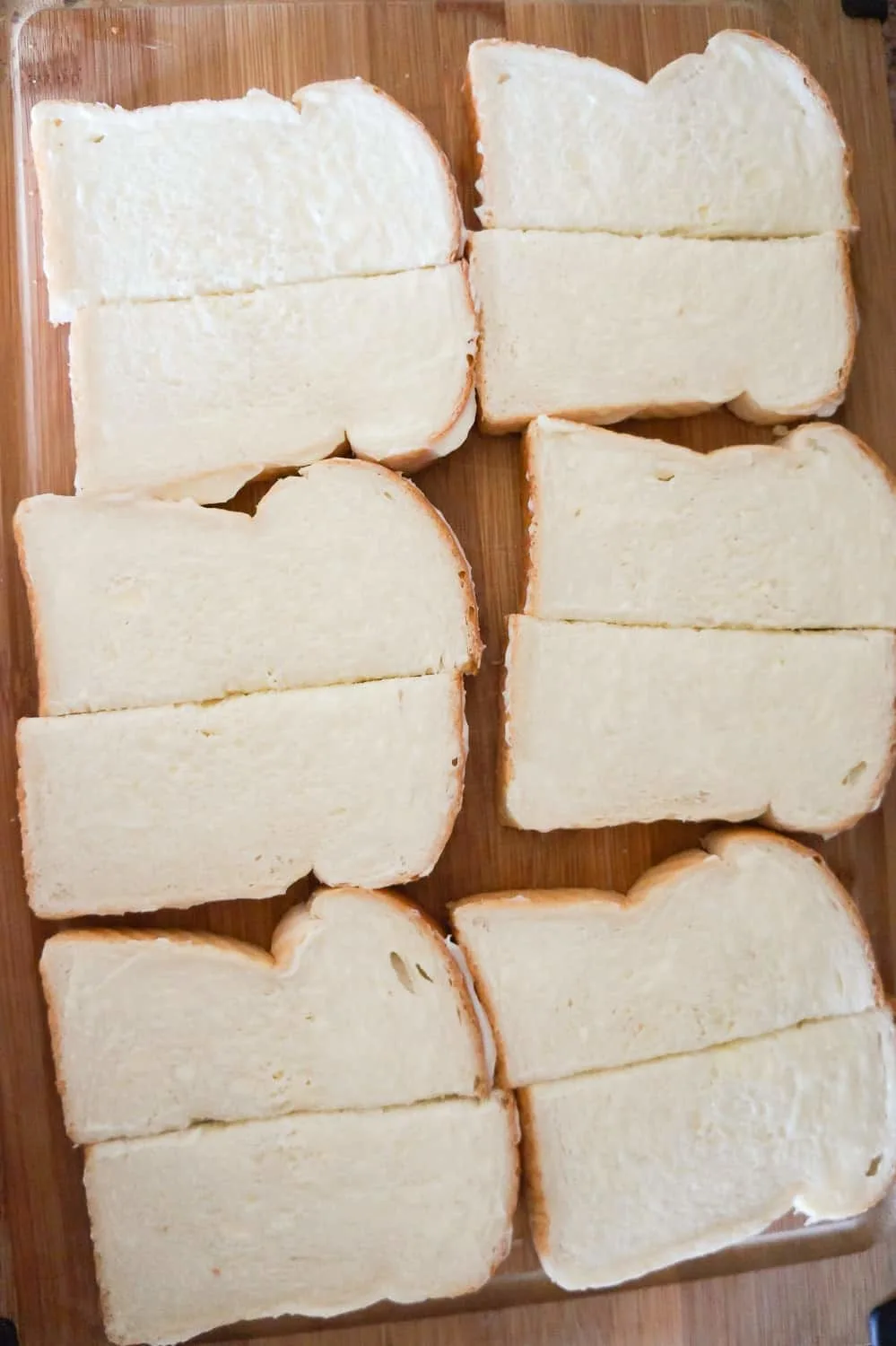bread slices on a cutting board cut in half